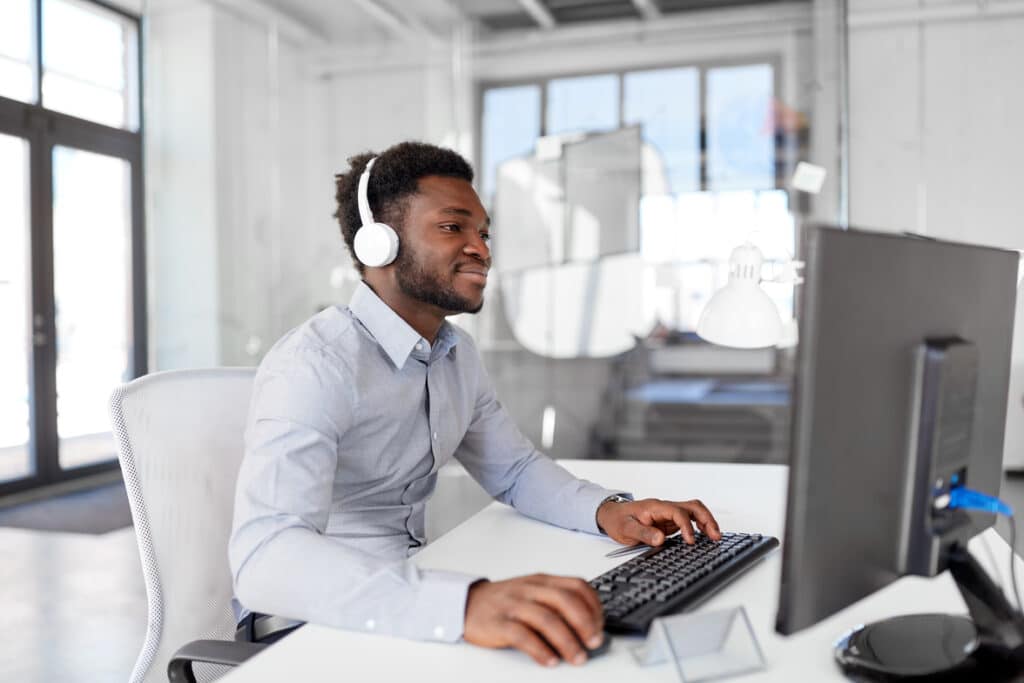 Man working at desk with headphones