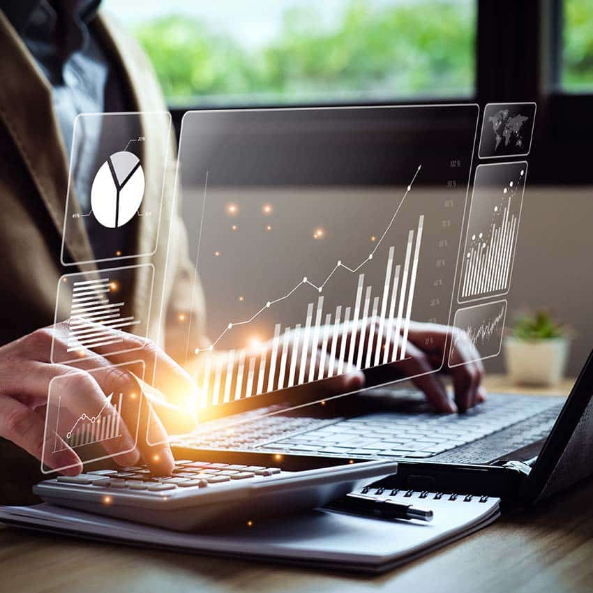 Person using a computer with graphs and charts overlaid