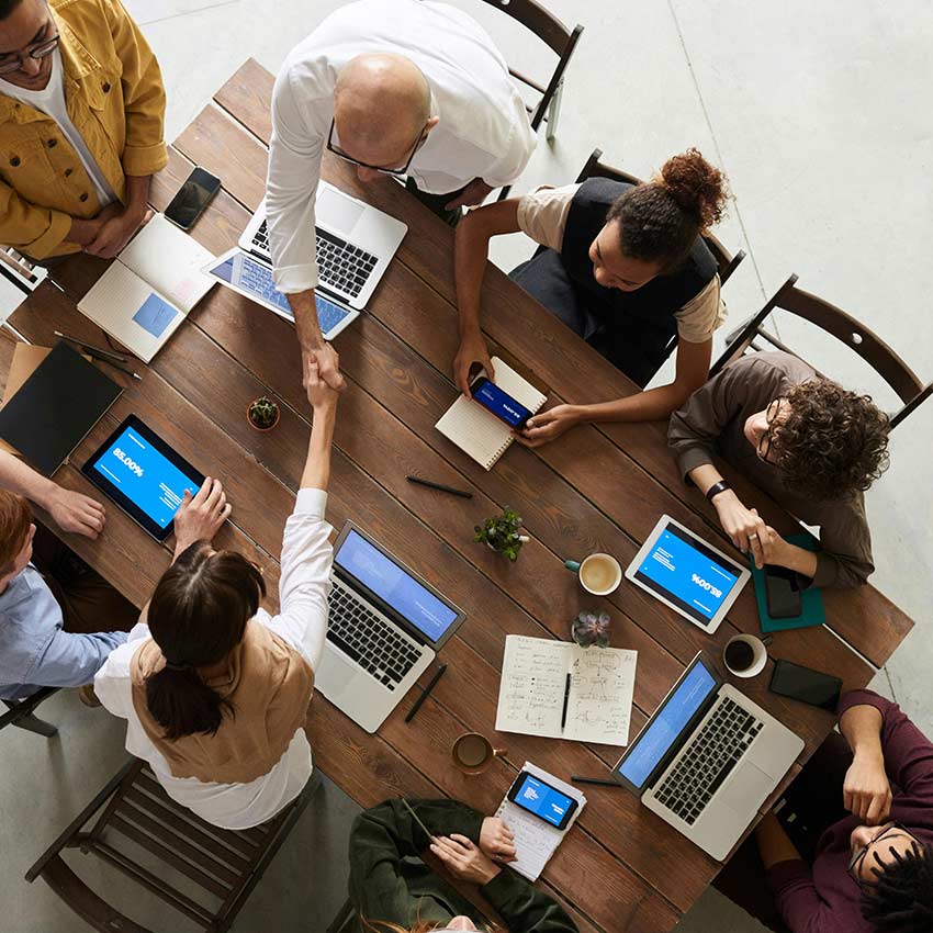 Top down of people collaborating around a table