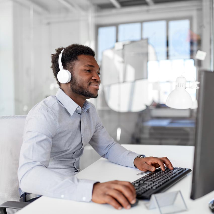 Man using computer with headphones